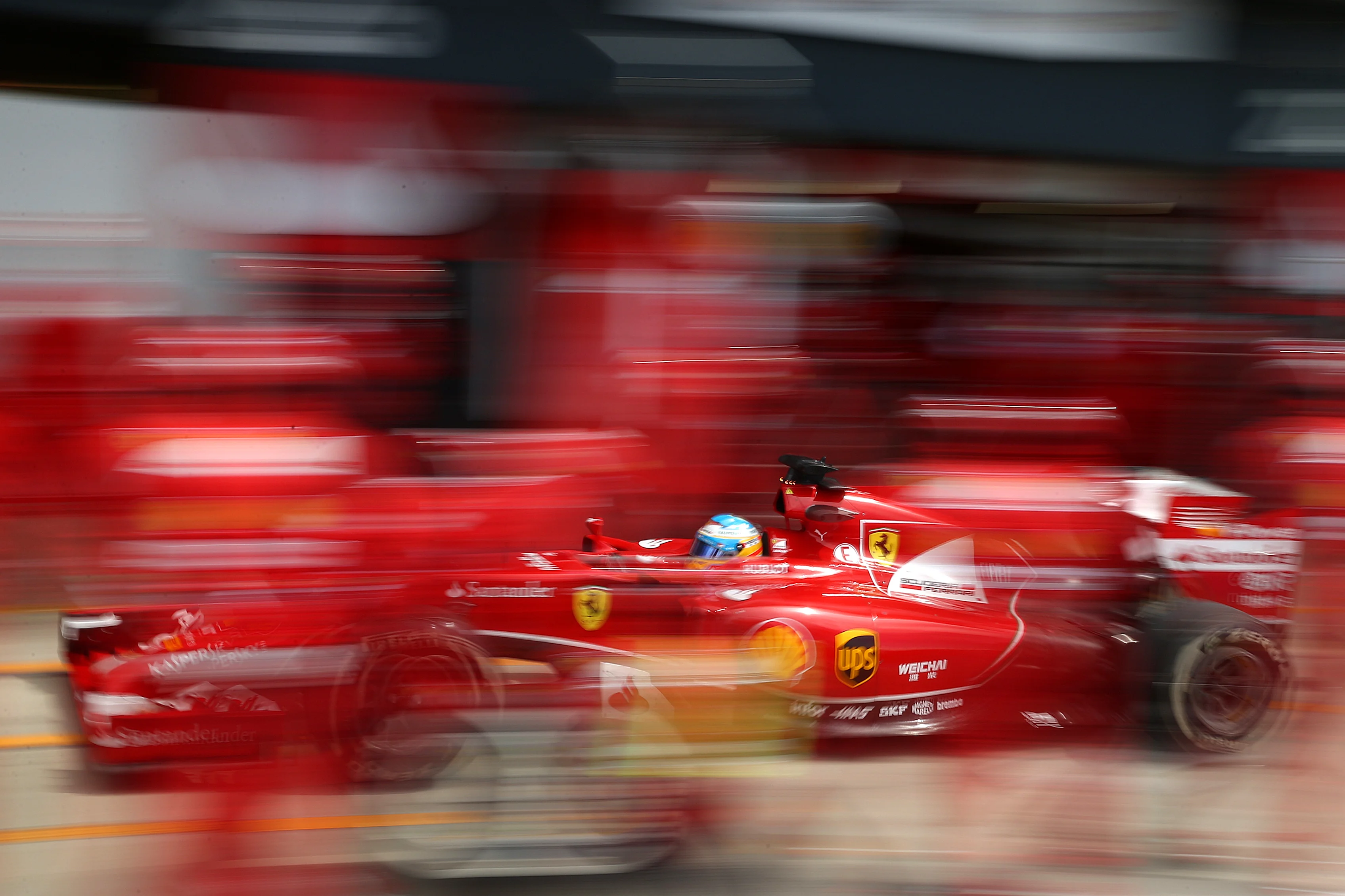 NORTHAMPTON, ENGLAND - JULY 06: Fernando Alonso of Spain and Ferrari makes a pit stop during the